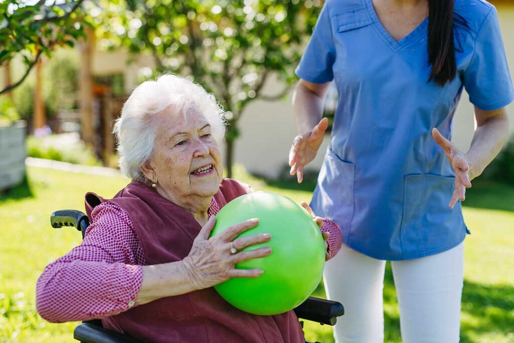 A senior resident greeting a family member in a comfortable common area.