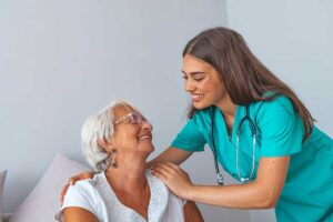 Older adult and family member review advance care planning documents at a kitchen table.
